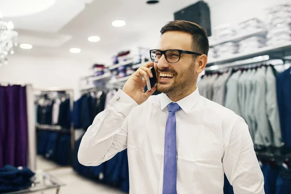 Smiling Young Man Buying a Shirt