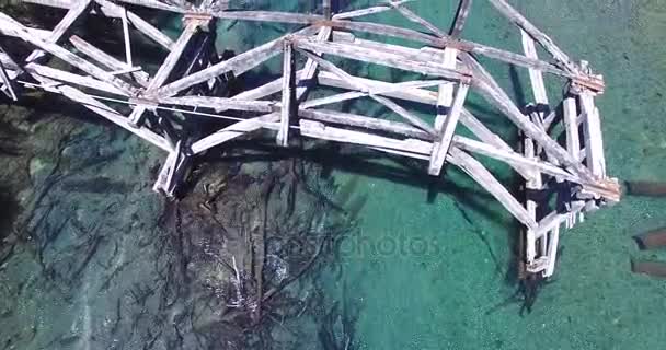 Aerial drone scene of old wooden bridge over blue transparent patagonia river. Ruca Malen. Top scene then descends to perspective view of forest on the coasts. Argentina. Ruta 40. — Stock Video