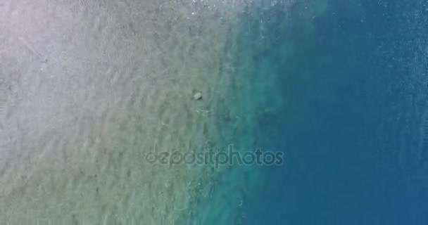 Aerial drone scene top view of transparent calm lake in patagonia argentina. Bottom of the lake with sand and plants. Green and blue. — Stock Video