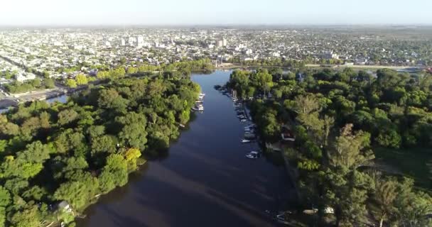 Aerial drone scene of city over natural river delta landscape. Panoramic view of Gualeguaychu city, Entre Rios, Argentina — Stockvideo