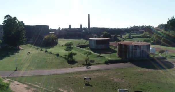 Aerial drone scene of abandoned industrial construction. Volume light. Ascending to general view of rusty architecture, The Anglo, Fray Bentos, Unesco, Uruguay — Stockvideo