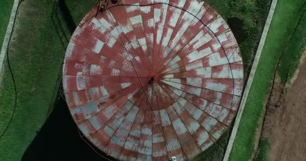Aerial top view of old rusty grain bin or silo. Circular grey and red structure, image rotating. The Anglo, Unesco, Fray Bentos, Uruguay — Stock Video