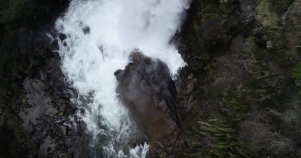 Top aerial detail of waterfall. Close up of steam, water vapor and power of water falling from cliff. Flying above waterfall traveling along stream. Natural wild surroundings. Vullignanco, Neuquen — Stockvideo