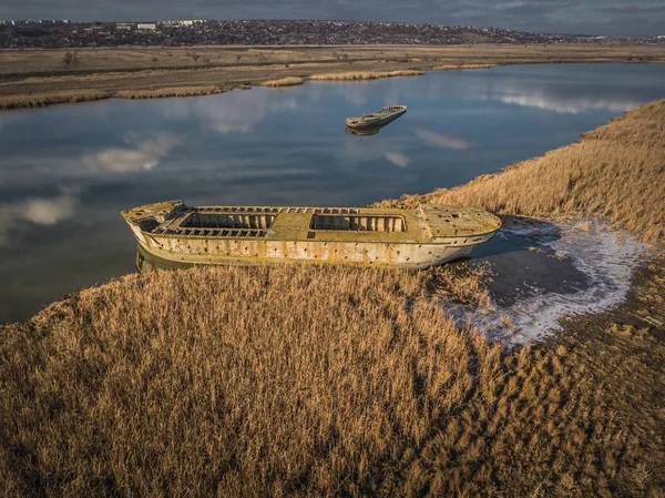 Barco roto abandonado en otoño río . —  Fotos de Stock