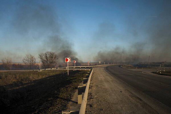 Burning steppe along the road.