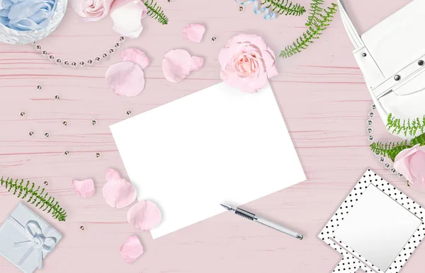 LIght feminine background. Flat lay. Pink roses, mirror, white bag on the pink wooden background.. Place for text. Cheerful mind every day