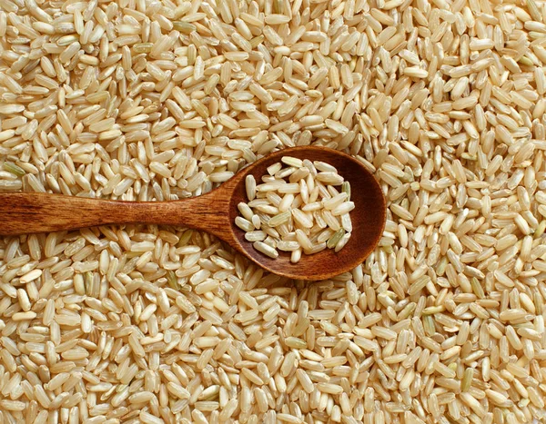 Pilha de arroz integral com uma colher — Fotografia de Stock