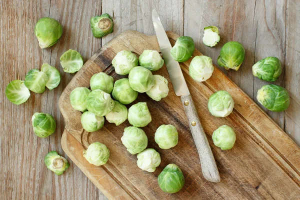 Brussels sprouts on a wooden board — Stock Photo, Image