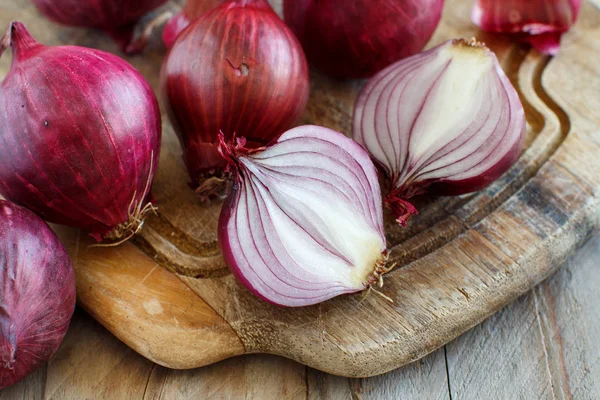Red onions on a wooden board — Stock Photo, Image