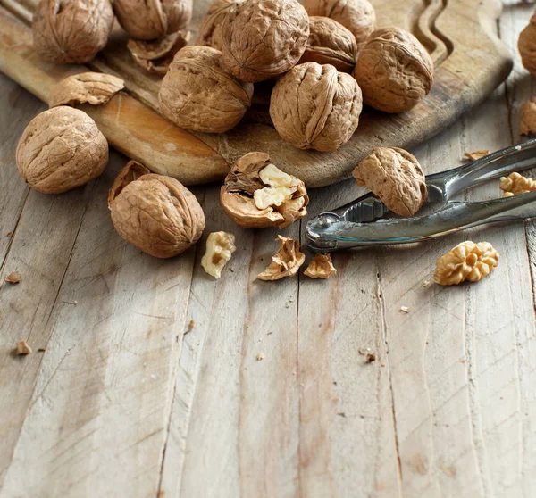 Fresh walnuts on an old wooden table — Stock Photo, Image