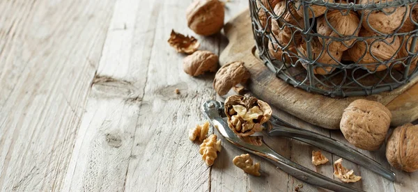 Fresh walnuts on an old wooden table — Stock Photo, Image