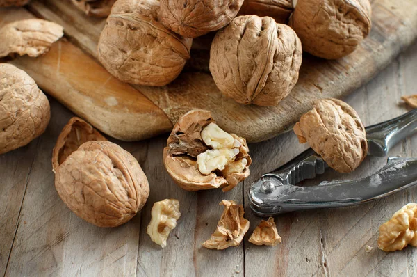 Fresh walnuts on an old wooden table — Stock Photo, Image