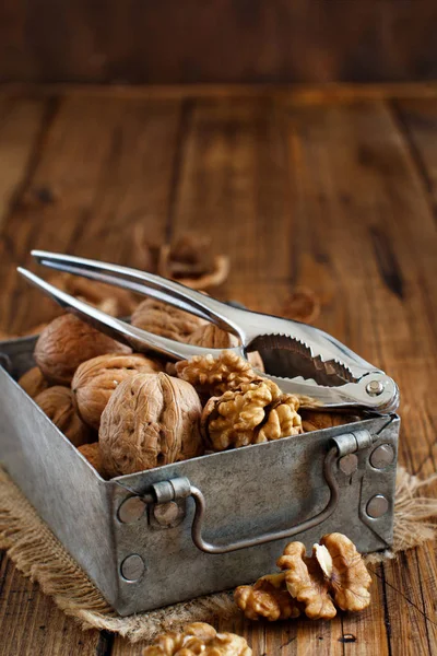 Fresh walnuts in a box on a  wooden table — Stock Photo, Image