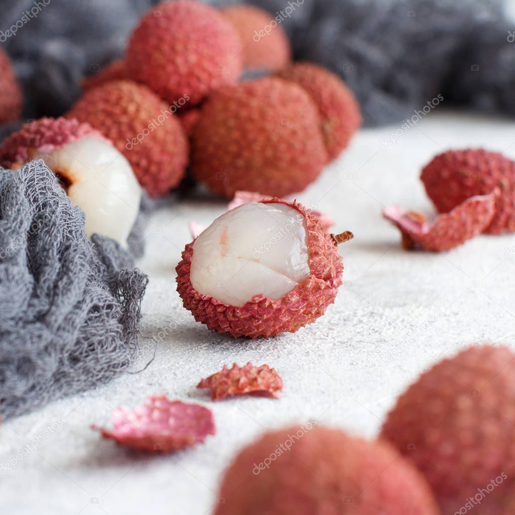 Fresh litchi fruits on a white table