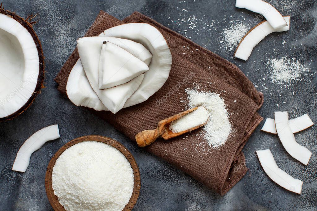 Coconut flour in a wooden spoon top view