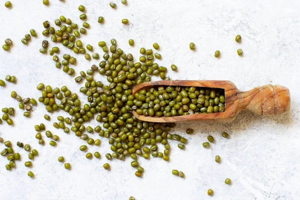 Dried mung beans with a spoon on a white background — 스톡 사진