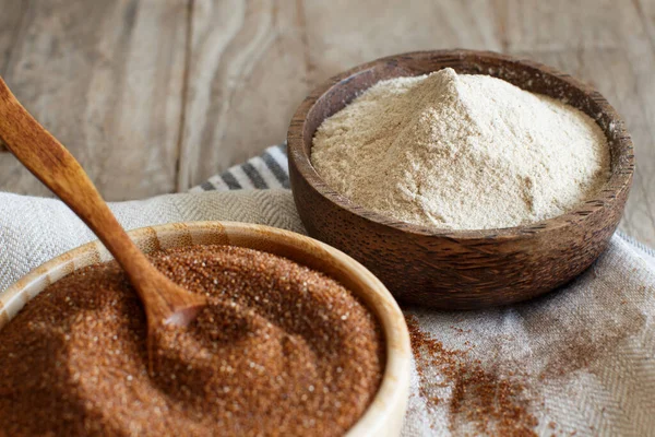 Teff flour and teff grain in bowls close up