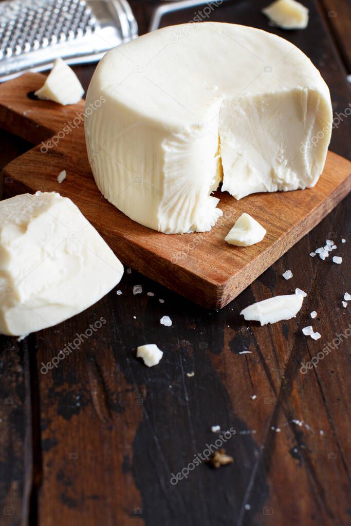 South Italian cheese cacioricotta on a wooden table close up