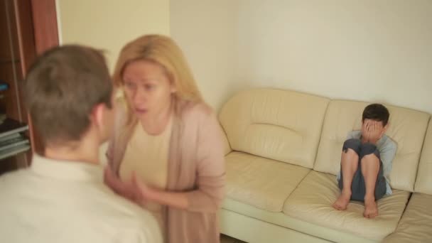 Parents quarrel with his son. mother and father arguing. stress in a child — Stock Video