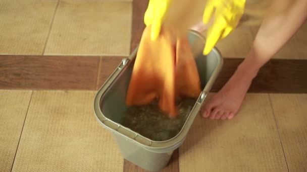 Vrouw reiniging van de vloer. meisje in handschoenen reinigt de keuken — Stockvideo