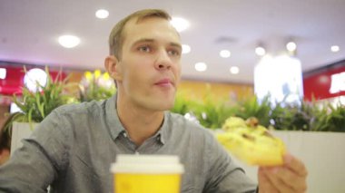 Genç adam café'de bir kahve içme. Pizza yemek