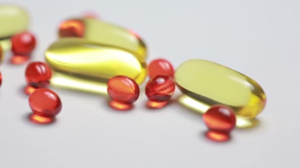 Cod liver oil omega 3 gel capsules on white background — Stock Video