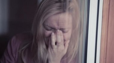 Pencere yakınındaki üzgün kız. plachet kadın. gözyaşları içinde schekah