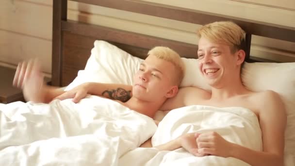 Homosexual couple lying on the bed. LGBT — Stock Video