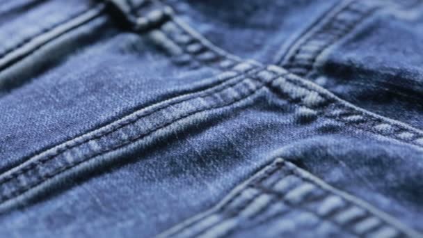 Blue jeans texture. can use as background. close-up of denim — Stockvideo