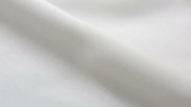 Beyaz pamuklu kumaş dokusu. Arka plan olarak kullanılabilir