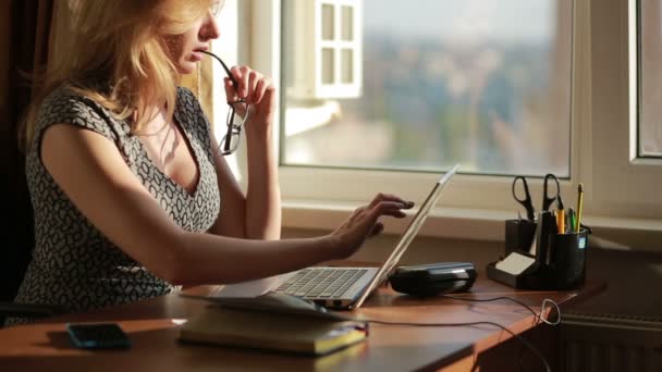 Сексуальная деловая женщина, работающая на ноутбук. присасывает очки — стоковое видео