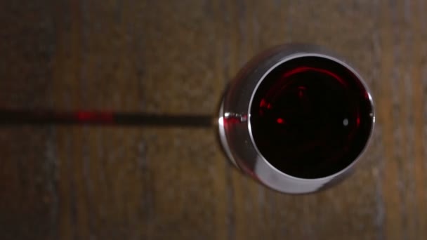 Detailní záběr ruky sommelier drží sklenku červeného vína. — Stock video
