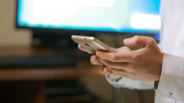 Primer plano de un niño utilizando el teléfono inteligente móvil el monitor de fondo — Vídeo de stock