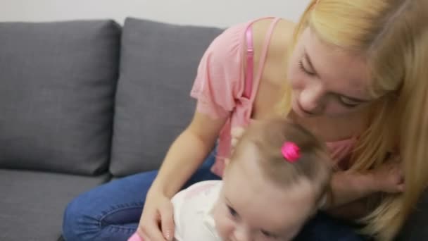 Mother with baby playing on couch — Stock Video