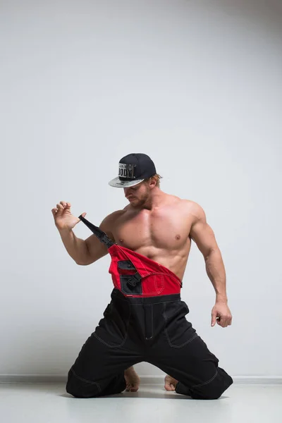 Muscular construction worker in overalls — Stock Photo, Image