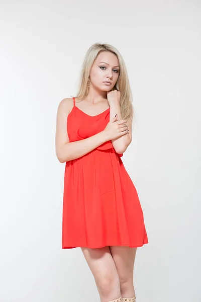 Young smiling woman in red dress. Isolated over white background. — Stock Photo, Image