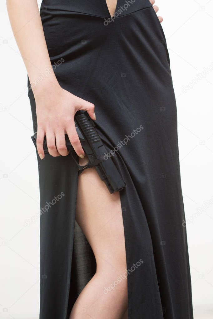 sexy woman in black dress holding gun