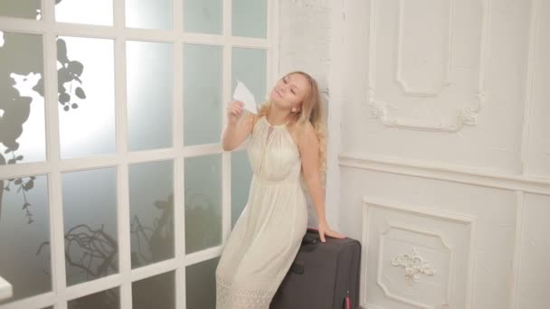 Pretty young girl holding an airplane made of paper — Stock Video