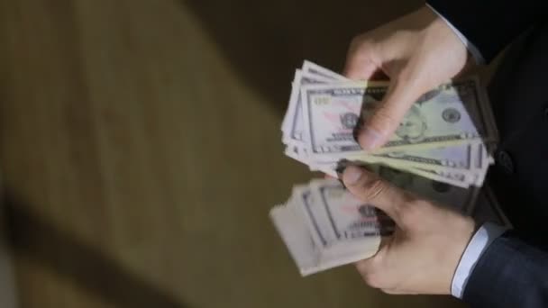 Мужчина бизнесмен находит пачку денег, долларов — стоковое видео