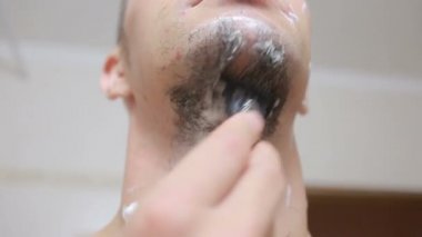 Banyoda bir ustura ile onun sakalı tıraş ve gülümseyen adam