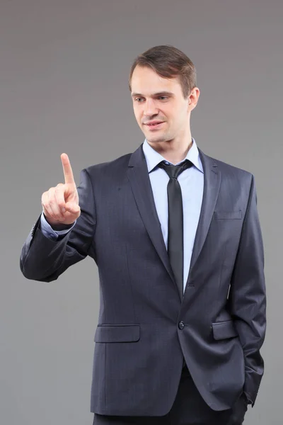 Executive man touching an imaginary screen — Stock Photo, Image