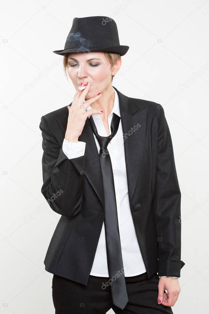 woman smokes a cigarette in business suit