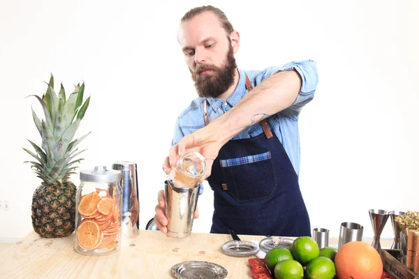 Bartender with a shaker and bottle. behind the bar — Stock Photo, Image