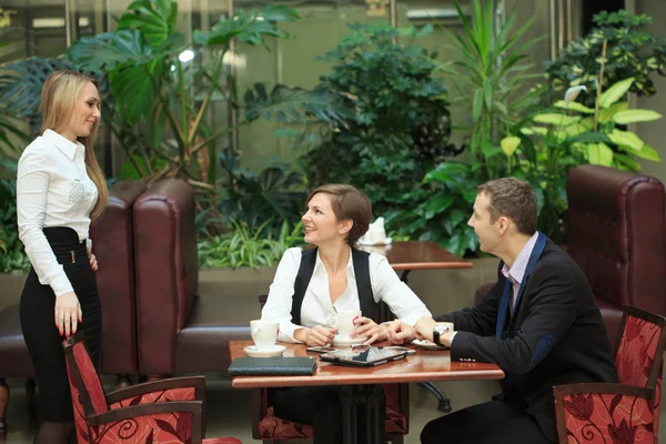 male and female colleagues in a cafe.