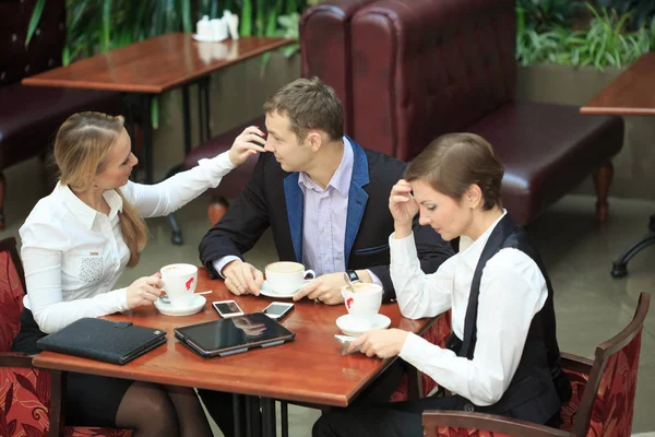 Des hommes d'affaires assis dans un café pour un ordinateur portable. deux filles — Photo