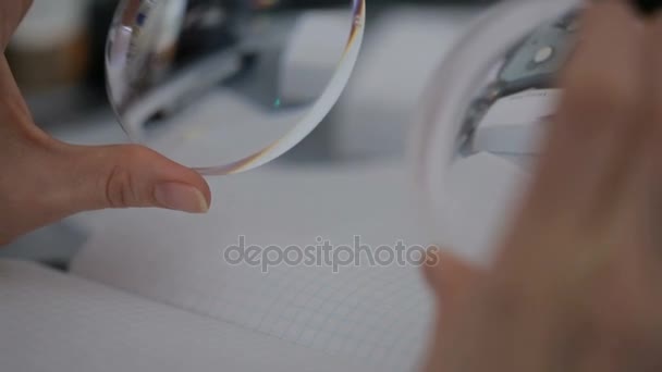 Optical round lens in female hands. inspection — Stock Video