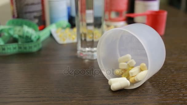 Protein, bcaa, omega3 in pills on wooden background. sports nutrition concept — Stock Video