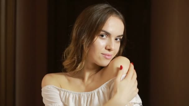 Krásná mladá bruneta dívka při pohledu na fotoaparát s úsměvem — Stock video