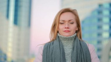 gökdelenler arka plan üzerinde modern bir şehir kız pembe bir ceket yürür