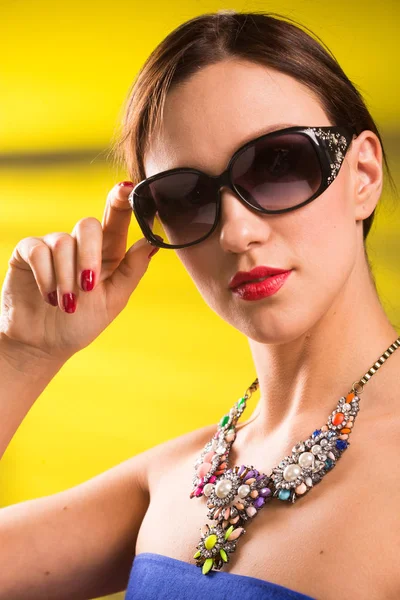 Necklace on the neck. ruby and emerald — Stock Photo, Image